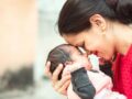 Indian woman holding infant baby in hand, outdoor shoot. four weeks old baby