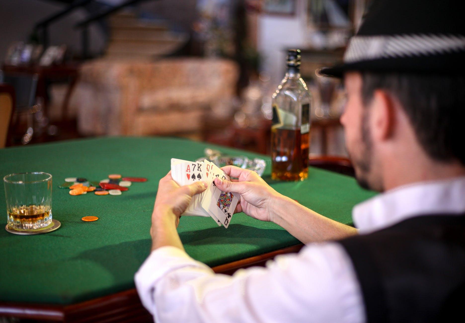 man holding playing cards