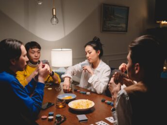 a group of friends playing poker while having conversation