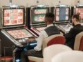men sitting in front of a slot machine