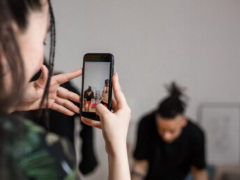 shallow focus of a person holding a smartphone while recording