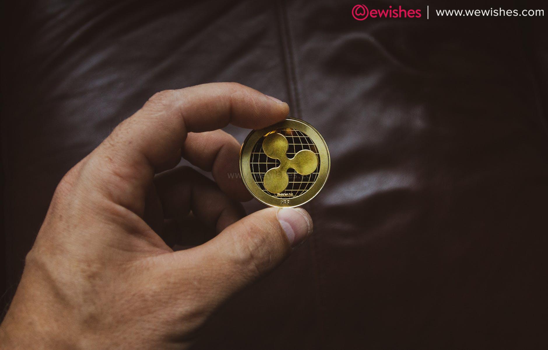 person holding a round golden coin